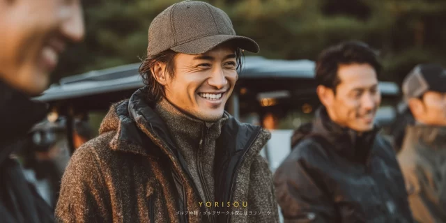 大阪府堺市西区浜寺元町周辺のゴルフ場で、40代男性ゴルファーがゴルフウェア姿でバストアップ、ラウンド前に仲間と談笑しながらリラックスした表情を見せている様子